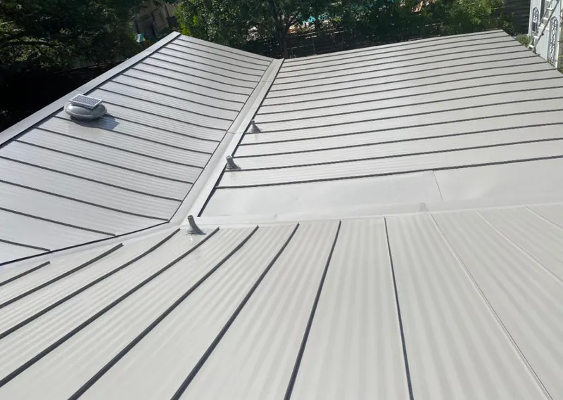 Solar attic fan installed on a metal roof for Roof Ventilation in Issaquah